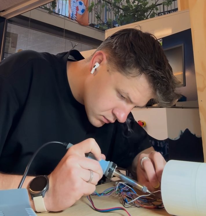 Damien Dufour soldering wires at a workbench