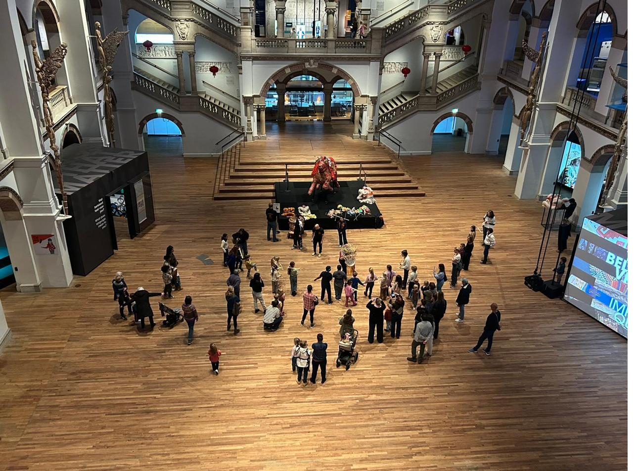 Lion dance performance in the museum grand hall viewed from the balcony